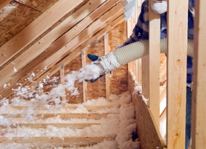 Blown in insulation into an attic space